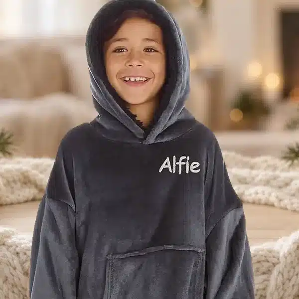 Boy in a charcoal personalised hoodie embroidered with Alfie