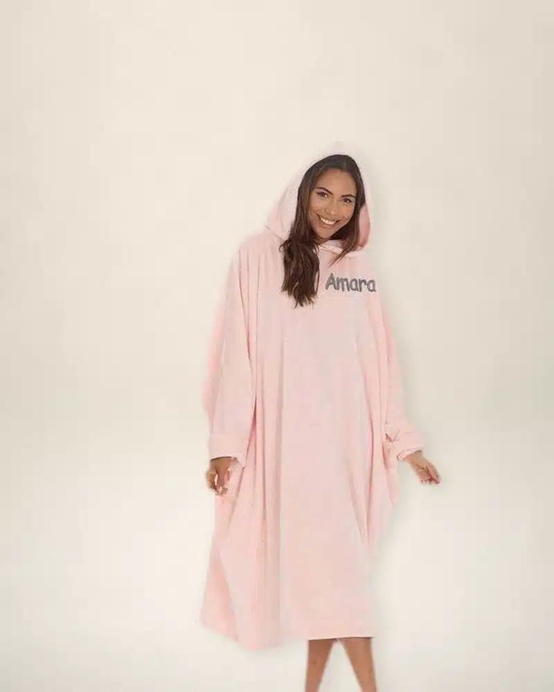 Woman wearing a pink personalised oversized hoodie embroidered with Amara