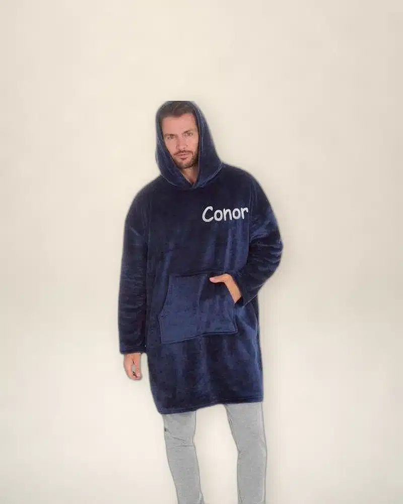 Man wearing a navy personalised oversized hoodie embroidered with Conor