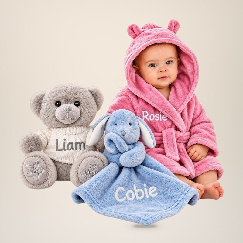 Baby in a pink bear-ear hooded robe embroidered Rosie, with a grey teddy embroidered Liam and a blue bunny comforter embroidered Cobie