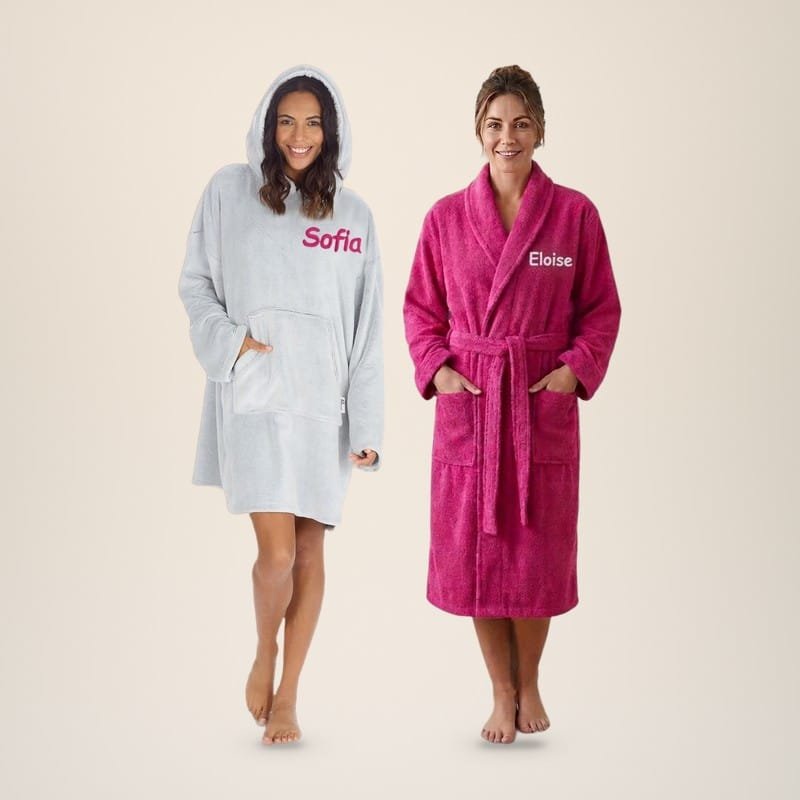 Woman in a grey personalised oversized hoodie embroidered Sofia next to a woman in a fuchsia towelling robe embroidered Eloise