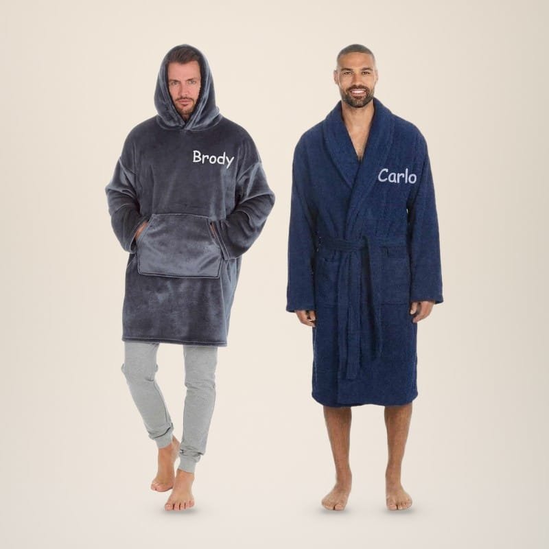 Man in a charcoal personalised oversized hoodie embroidered Brody next to a man in a navy towelling robe embroidered Carlo