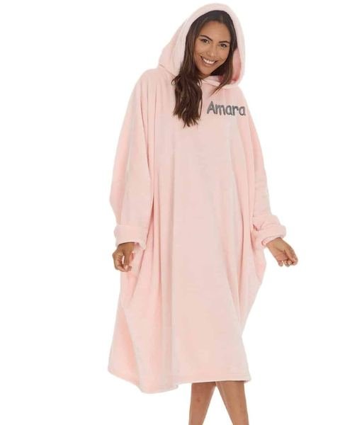 Woman wearing a pink personalised oversized hoodie embroidered with Amara