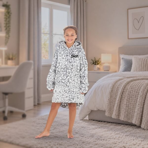 Personalised kids oversized hoodie in leopard print, girl in a bedroom
