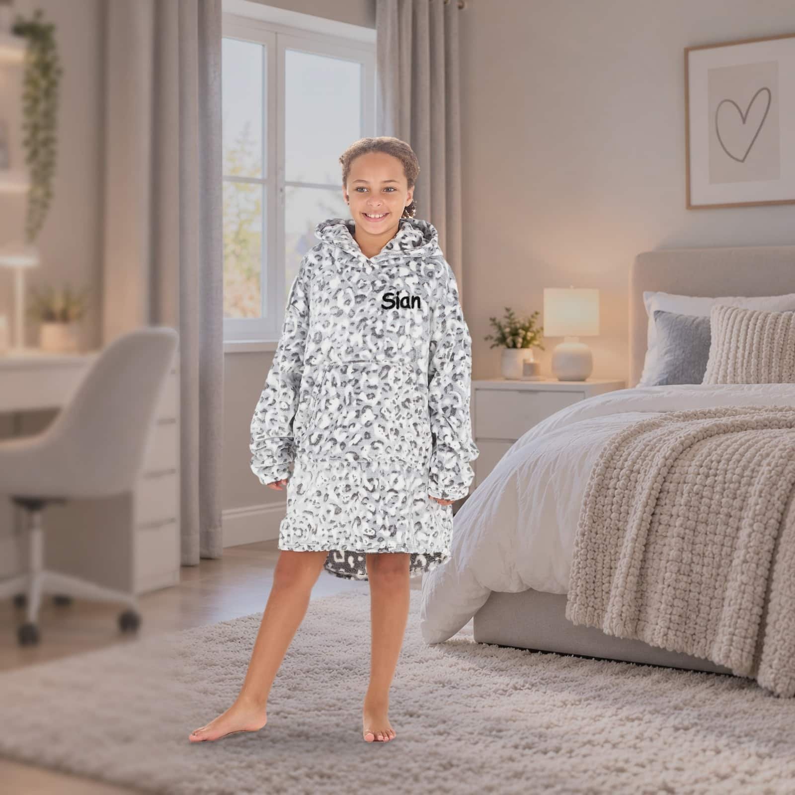 Personalised kids oversized hoodie in leopard print, girl in a bedroom